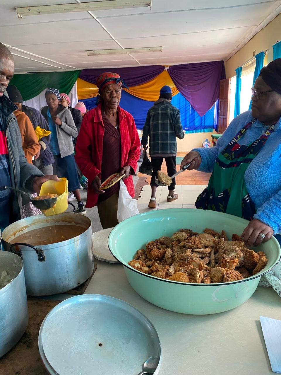 Community feeding programme volunteers serving a meal